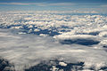 Cumulus clouds in the foreground and background with stratocumulus in between.