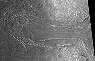 Probable glacier as seen by HiRISE under HiWish program. Radar studies have found that it is made up of almost completely pure ice. It appears to be moving from the high ground (a mesa) on the right.