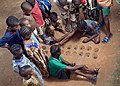 Board game without a board: children in Nigeria play Mancala variant Ayo