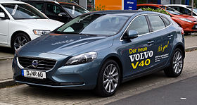 Picture of a blue hatchback car with livery on the doors