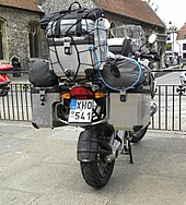 Rear view of motorcycle fitted with panniers, top box, and extra soft luggage