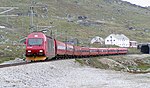 An NSB El 18 hauled express train just leaving the Finse Tunnel