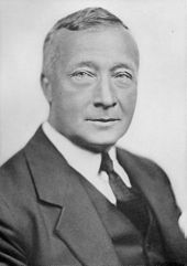 Black and white photo of a middle-aged man wearing a suit and necktie