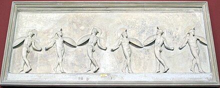Relief of nude men with shields dancing.