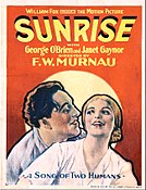 The theatrical poster of Sunrise. George O'Brien holds Janet Gaynor from behind as they are in front of the sunup.