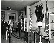 black and white image the Hoover desk on display behind a velvet rope