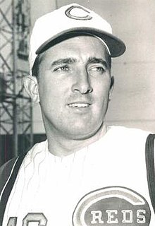 A man in a light baseball uniform