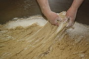 2. The baker removes enough dough to make one loaf of bread.