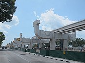 Pillars installed along a road, with a bare station structure