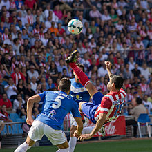 Photograph of a man who is about to kick a football