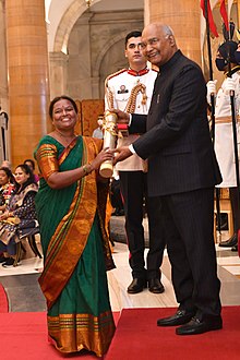 Man presents award to woman