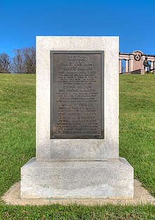 Photo shows a rectangular stone marker with a bronze plaque.