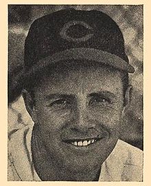 A man in a light baseball uniform and a dark cap with a "C" on the center