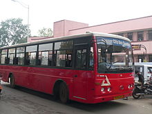 Red bus with large windows