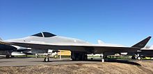 The YF-23 painted light gray, the "Spider", can be seen at the center with its labels. An unmarked fighter jet is at its left, while a Navy aircraft is to the right, marked VF-2, probably the squadron it belonged to.