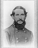 Blank and white photo of a young bearded man in a military uniform.