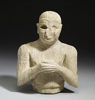 Ancient Sumerian calcite-alabaster figurine of a male worshiper. 2500 BCE - 2250 BCE. The inscription on his right arm mentions Ninshubur.
