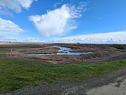 A photograph of a field on an island.