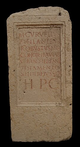 A rectangular block of stone with a Latin inscription.