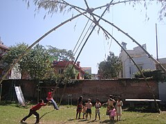 Children standing in a queue for the swing