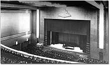 Photograph of an audience watching a performance inside the Eaton Auditorium