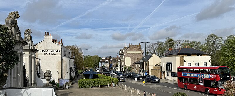 Hampton Court Road streetscape outside the Lion Gate of Hampton Court Palace, showing a restaurant styled after the wives of Henry VIII