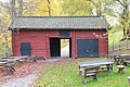 Hewn log barn painted red in Hedemora, Sweden.