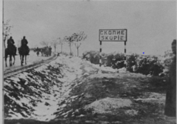 Two horsemen and troops entering Skopje
