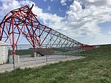 The WMT (AM) radio tower crumpled by est. 130 mph (210 km/h; 58 m/s) winds north of Marion, Iowa.