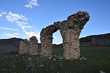 Remains of colossal arches, mostly fallen down