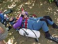 A diver putting on his belt style sidemount harness. Getting up afterwards often required assistance.