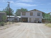 Extension of the Earl Bayless House which was used as a store and which is located at 211 N. Cameron St. It was listed in the National Register of Historic Places in 1985, reference #85000878.