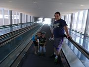Family crossing over Washington St. at the PHX Sky Train's main terminal at 44th St. station.