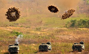 USMC AAVs firing smoke grenades during a training exercise