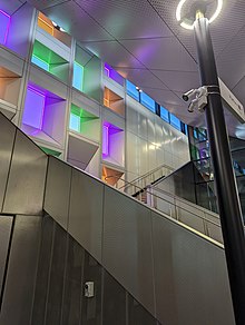 The coloured windows at Bell railway station, Preston with the staircase leading to the platform in the foreground
