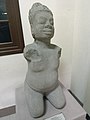 This statue of a kneeling fat man wearing a mukuta and a mustache is from the 9th century.