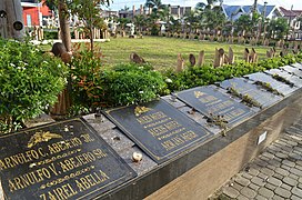 Mass graves of victims of Typhoon Haiyan within the cathedral grounds