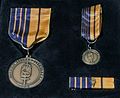 Medal, ribbon and miniature of the Northern Military District Commemorative Medal.