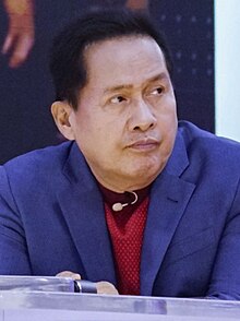 Headshot of Apollo Quiboloy. He is a Filipino man in his seventies with short hair and brown skin.