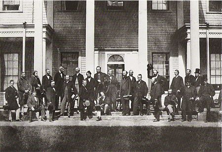 Delegates from the Legislatures of Canada, gathering on the steps of Prince Edward Island's Government House for the Charlottetown Conference – Photo by George P. Roberts on September 11, 1864.