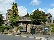 A church with a lych-gate in the foreground