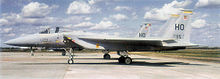 A jet sits perpendicular to the camera while parked on a tarmac