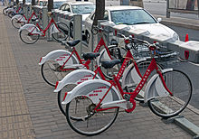 A rack of red-and-white bicycles, locked into place