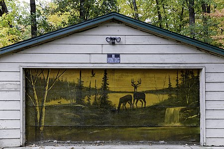 No Hunting sign on garage with painting of deer in McGregor, Minnesota