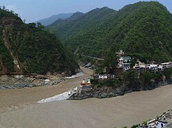 Confluence of Alaknanda (bottom, from right) and Mandakini River (flowing from top - North) at Rudraprayag. Before 17 June 2013, there was a footbridge (jhula) over the Mandakini; this was washed away in the 2013 Uttarakhand floods. The stones at the bottom of the stairs were not there; instead, there was a viewing platform, and a large rock called Narad Shila.