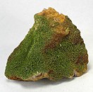 Green pyromorphite crystals densely carpet the display side of the large matrix