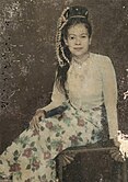 Hand-coloured studio portrait of a woman in Burma, ca. 1910