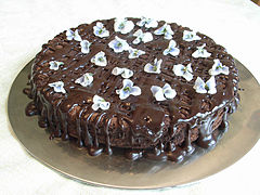 A chocolate cake garnished with violets