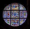 Stained-glass window above altar depicting the life of Mary