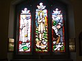 Stained glass west window depicting Pope John XXIII, Kateri Tekakwitha and Jerzy Popiełuszko